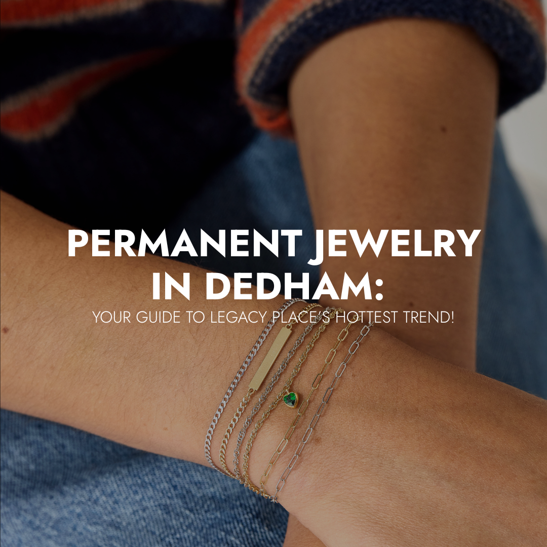 Close-up of a person wearing multiple delicate layered permanent bracelets on their wrist, with text overlay that reads “Permanent Jewelry in Dedham: Your Guide to Legacy Place’s Hottest Trend.”