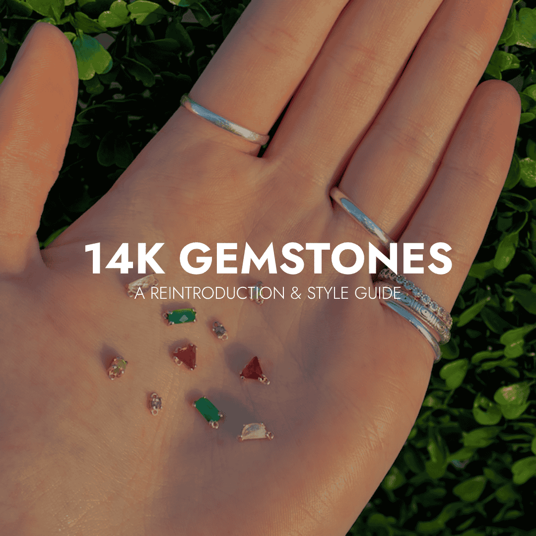 Hand holding 14k gemstone charms in sunlight, showcasing Brave Daughters’ gemstone options.