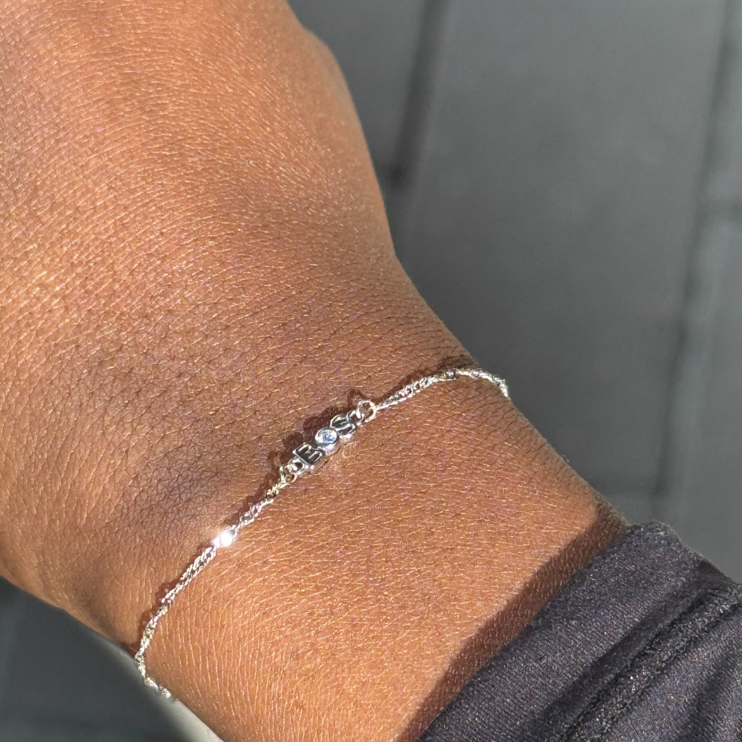 Thin Helix Boston Bracelet in solid 14K white gold with custom charm and lab-grown diamond on wrist, showcasing fine jewelry craftsmanship by Brave Daughters.