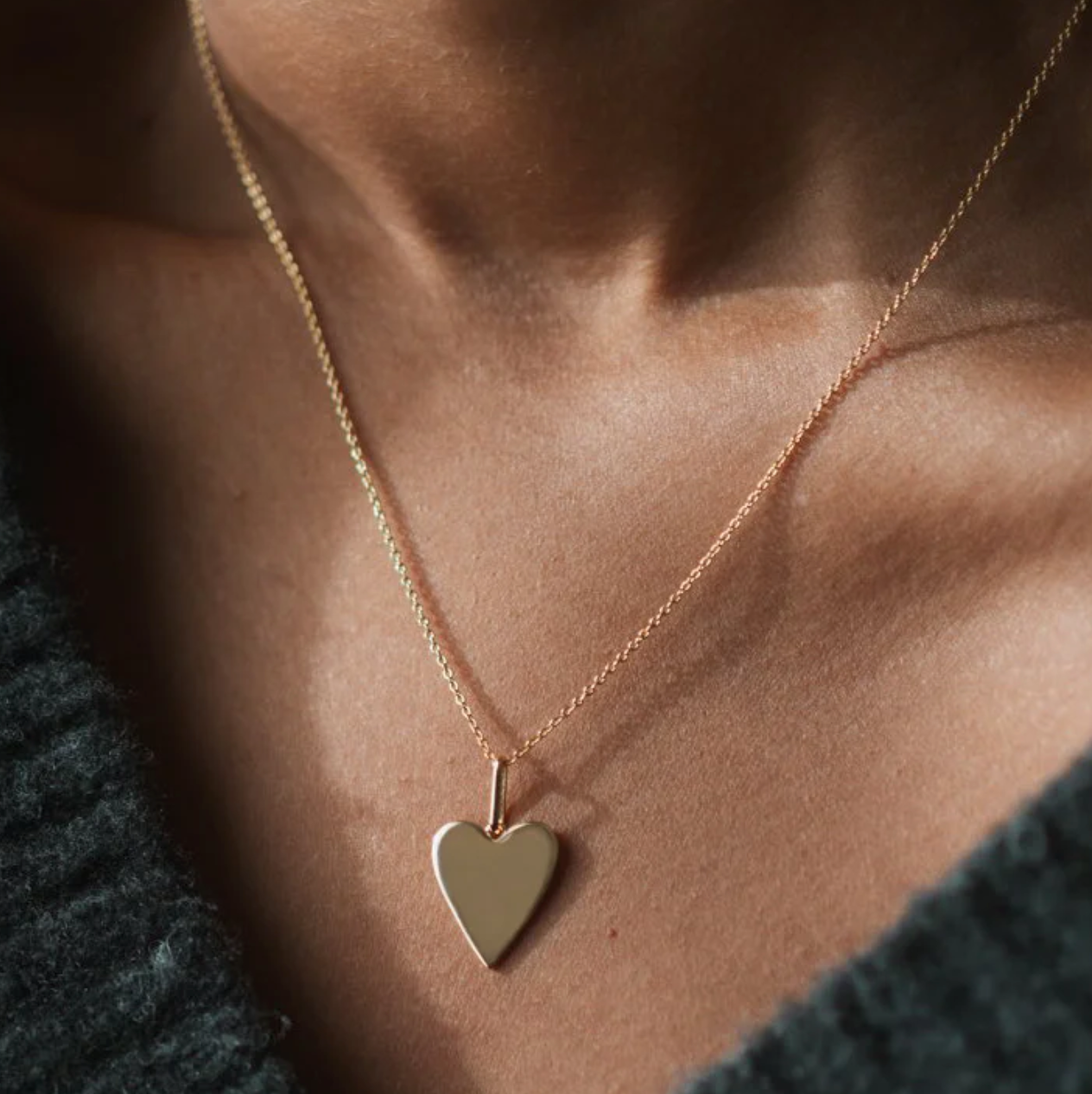 14k gold plated Amaya Heart Charm necklace worn on a model, showcasing minimalist design and elegance.