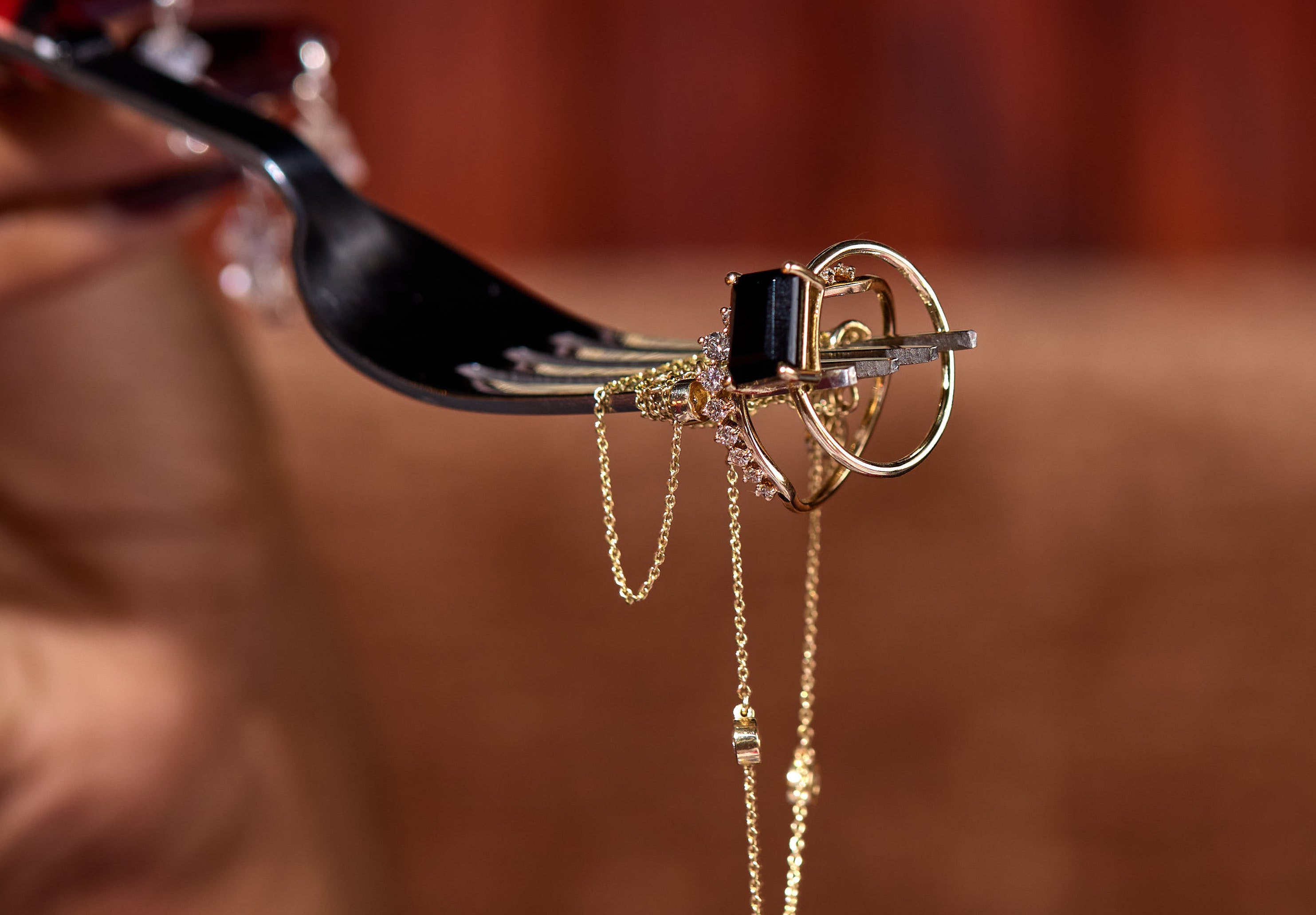 Brave Daughters team welding permanent bracelets at a private event — custom fine jewelry experience featuring delicate gold chains and personalized service in an intimate setting.