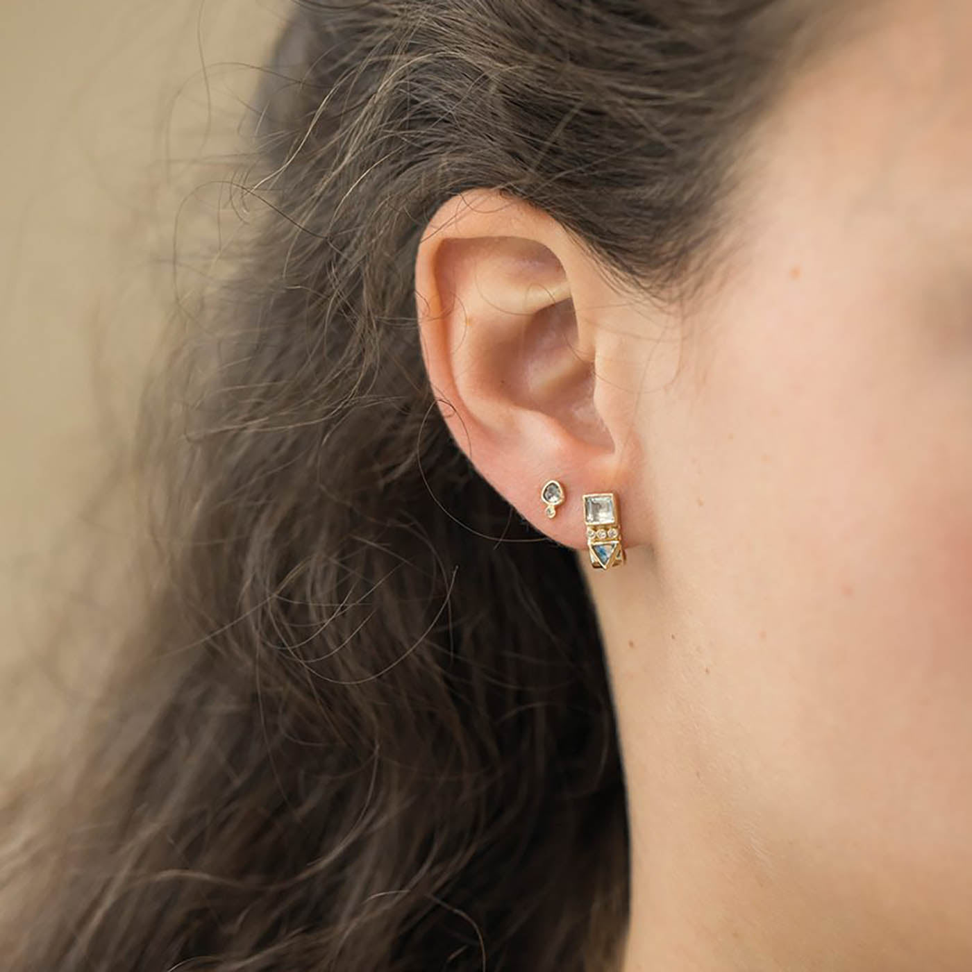 Totem Moonstone and Diamond Single Cuff Stud Earring worn in ear, showcasing unique design and luxury materials, highlighting feminine energy and protective talisman significance.
