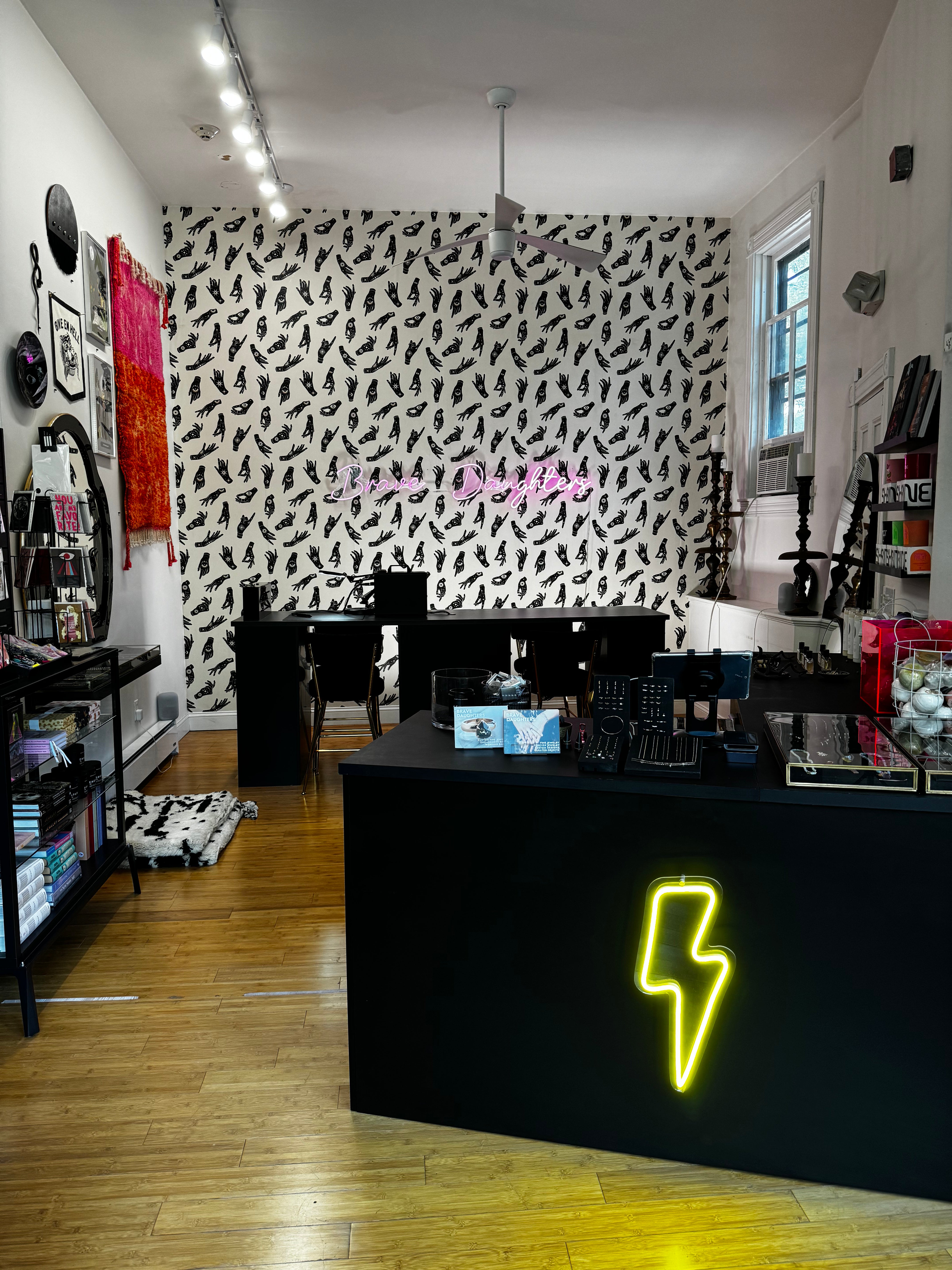 Brave Daughters Providence studio — boutique jewelry space with permanent bracelet welding, curated fine jewelry, and bold graphic design elements in Rhode Island.