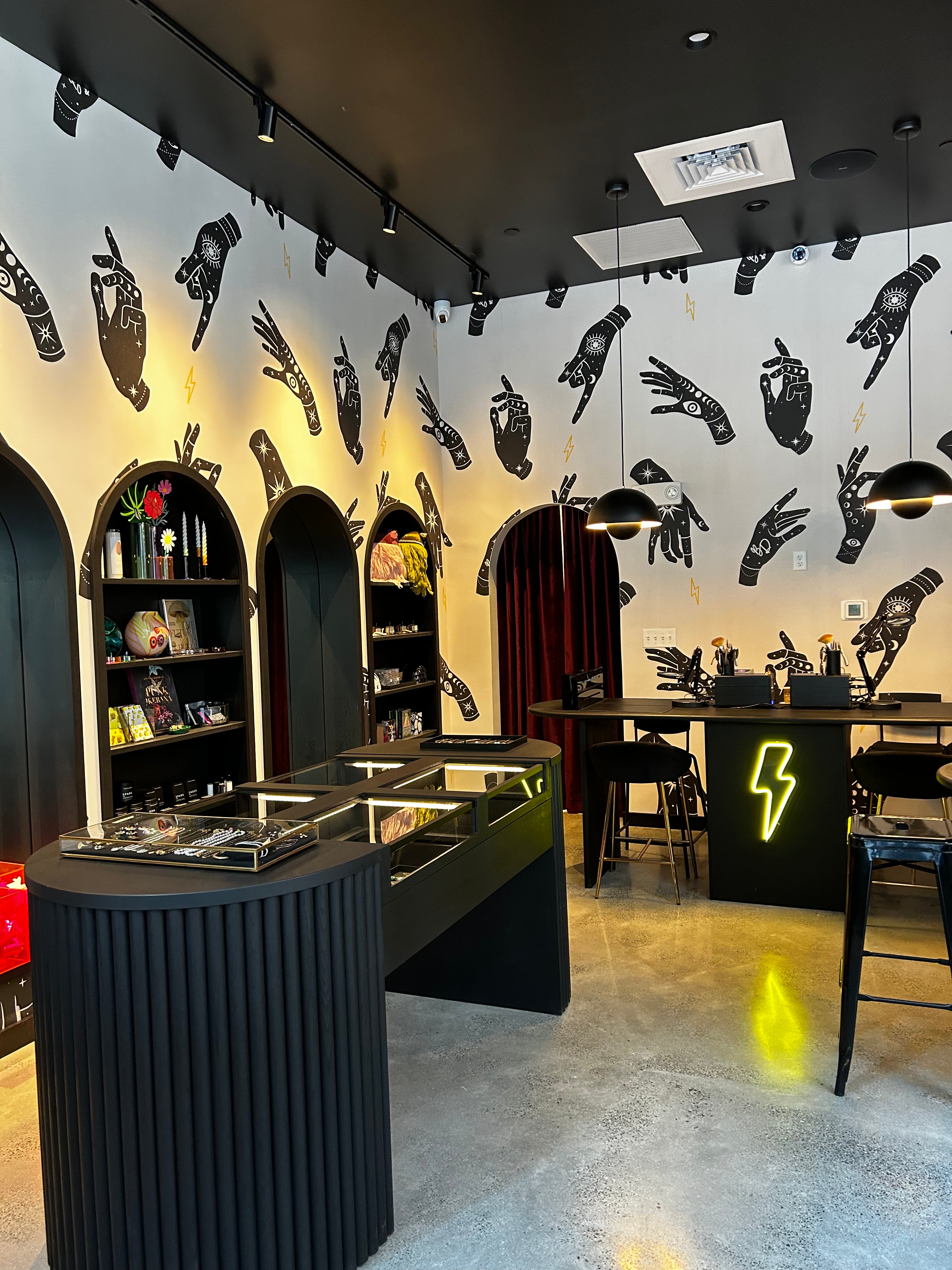 Brave Daughters Seaport Boston location — boutique studio with permanent jewelry welding bar, curated fine jewelry, and bold graphic interior design.
