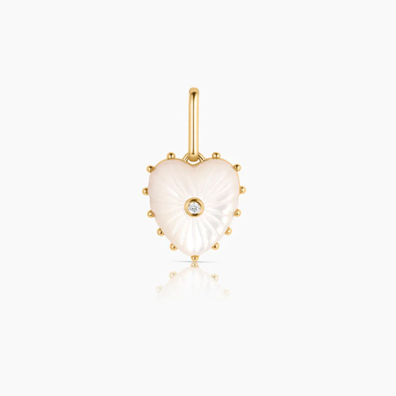 Heart-shaped pendant made of hand-carved mother of pearl, featuring a cubic zirconia centerpiece and gold-plated accents, designed for the Malene Mother Of Pearl Clip Necklace by Brave Daughters.