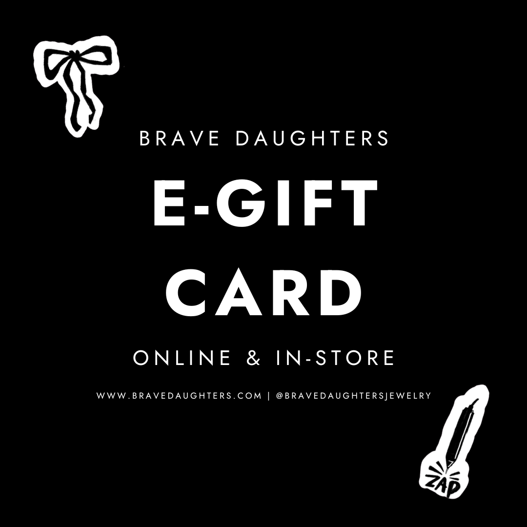 Brave Daughters e-gift card design featuring bold text on a black background, promoting online and in-store use, with decorative elements including a bow and a zap symbol.