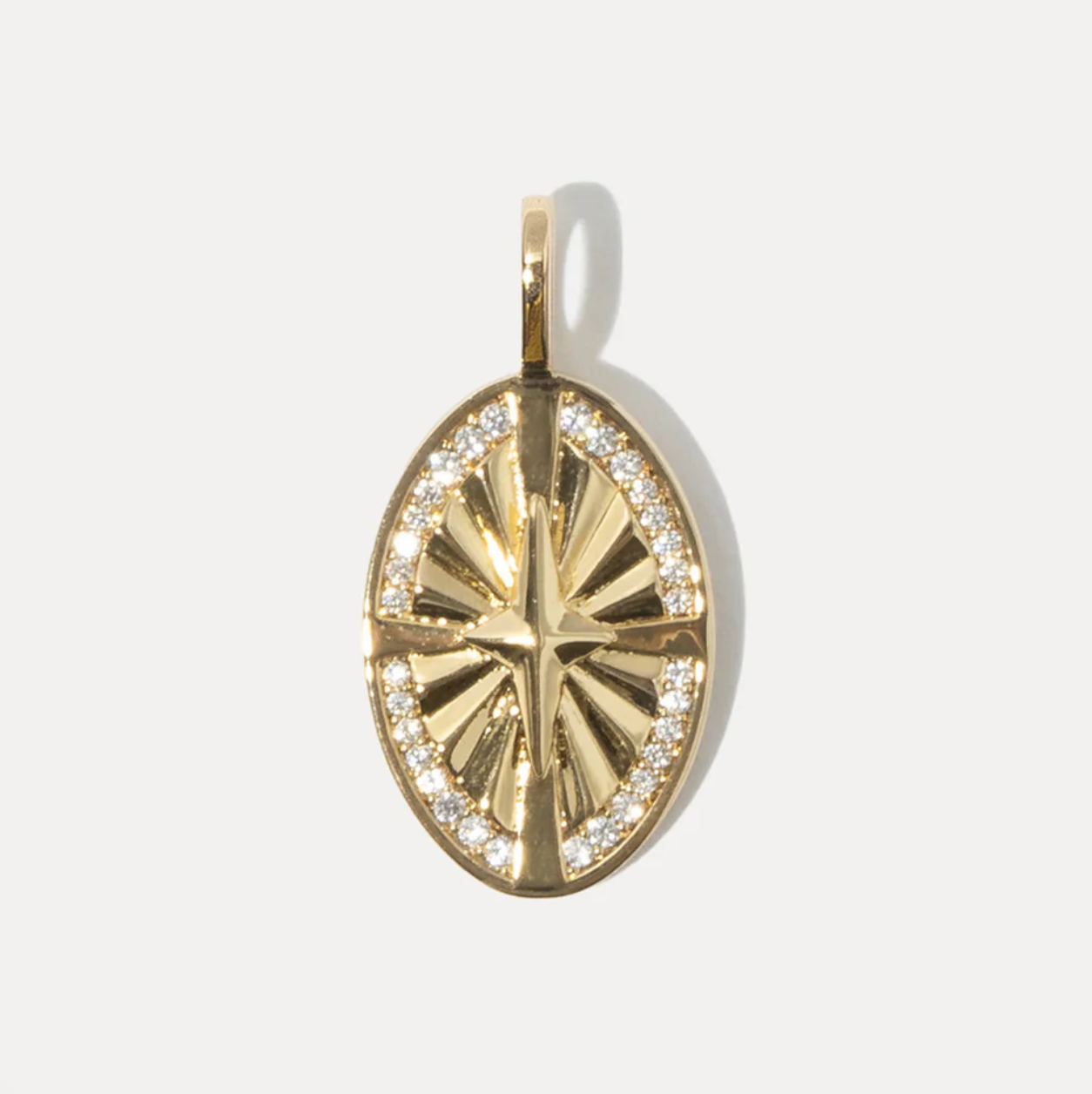 Gold pendant with CZ accents on a white background