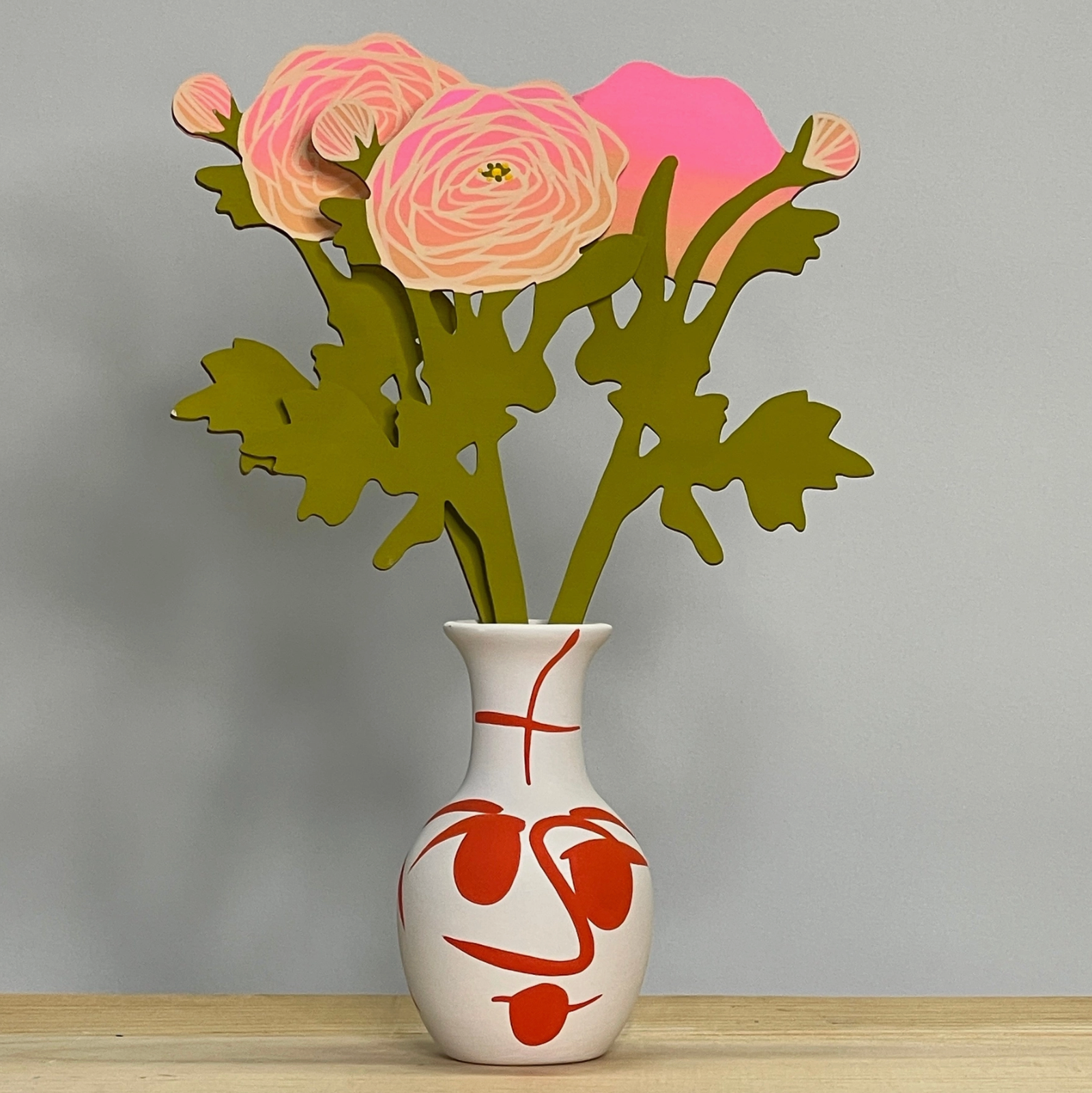 Handcrafted vase featuring colorful, hand-painted Ranunculus flowers and green foliage, representing the Forever Flower decorative item from Brave Daughters.