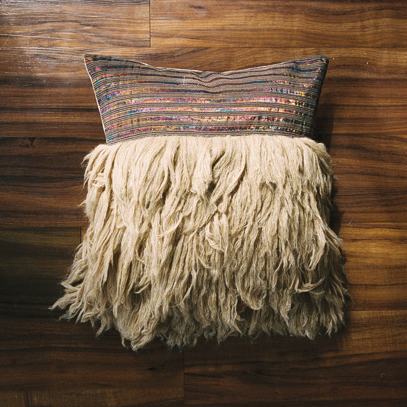 Holographic and Brown Textured Throw Pillow on Wood Floor