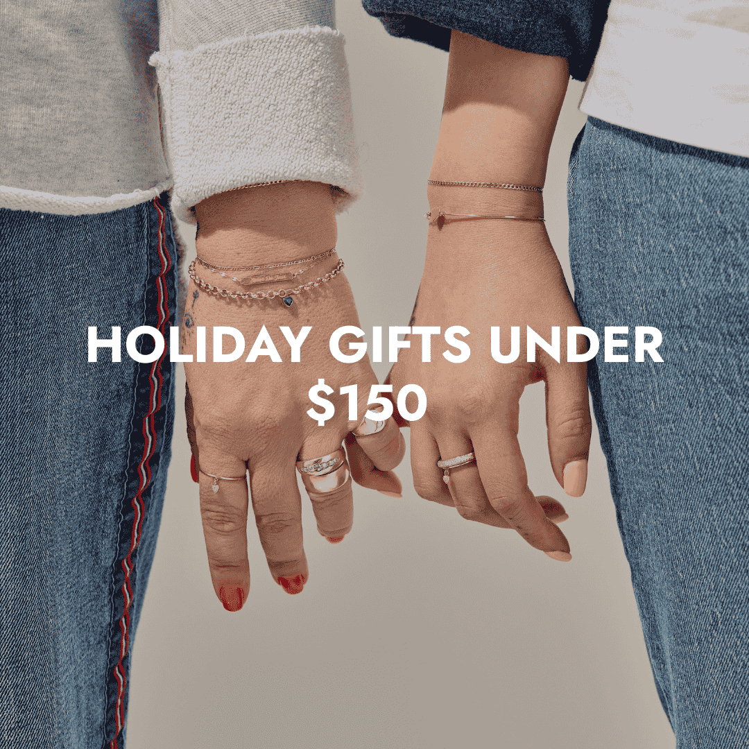 Hands wearing bracelets and rings showcasing permanent jewelry and affordable luxury accessories, promoting holiday gifts under $150 and budget-friendly gift ideas.