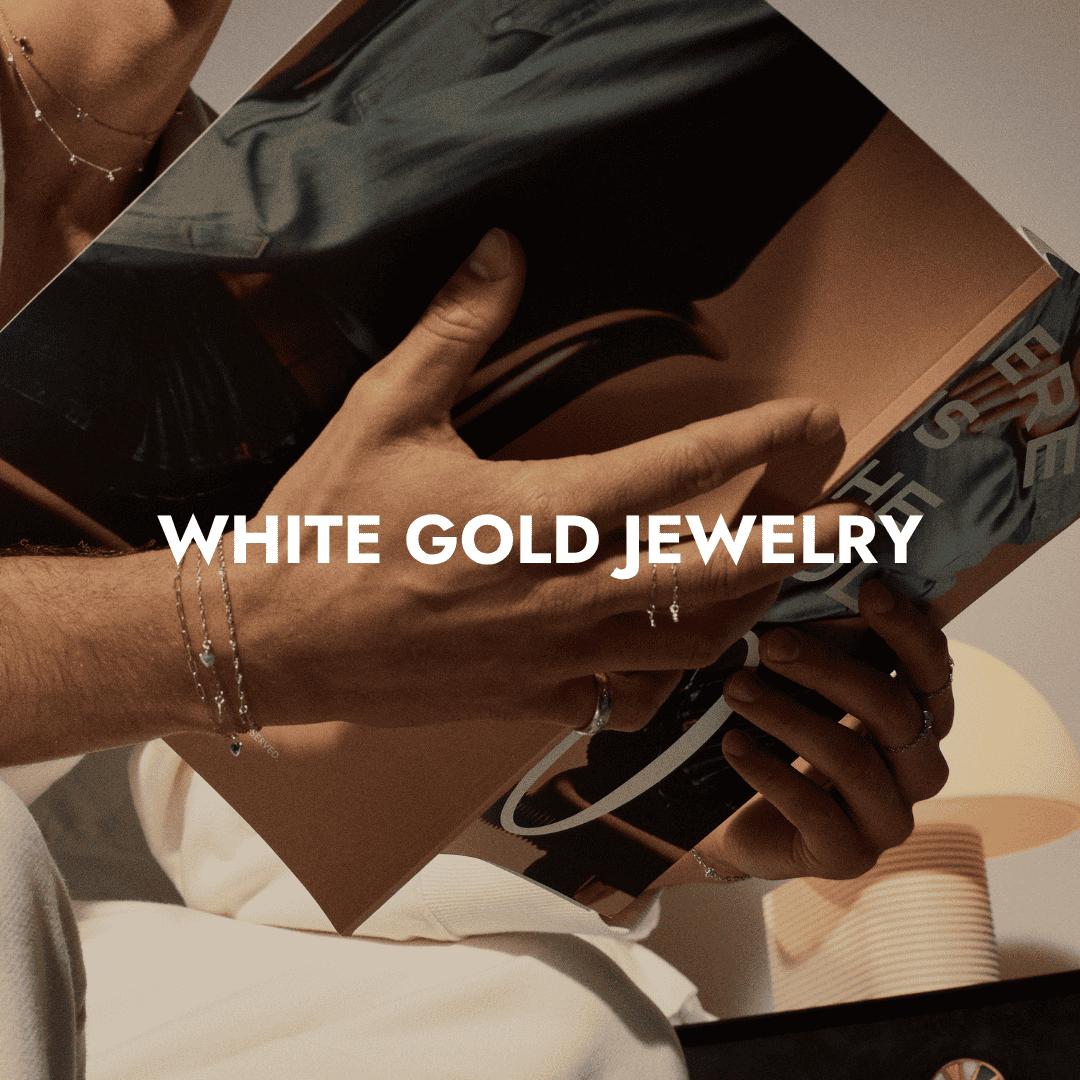 Close-up of hands wearing Brave Daughters white gold jewelry.