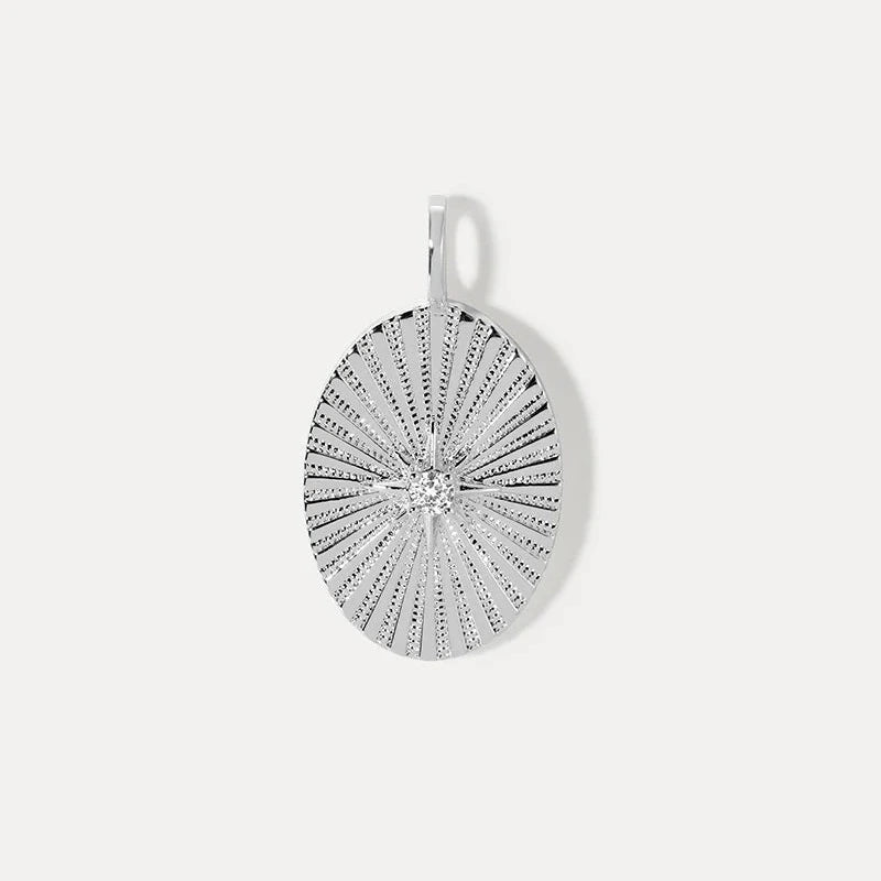 a gold oval charm with a star motif and stone accent on a white background