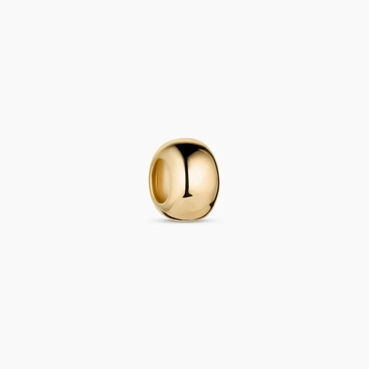 a gold bead charm over a white background