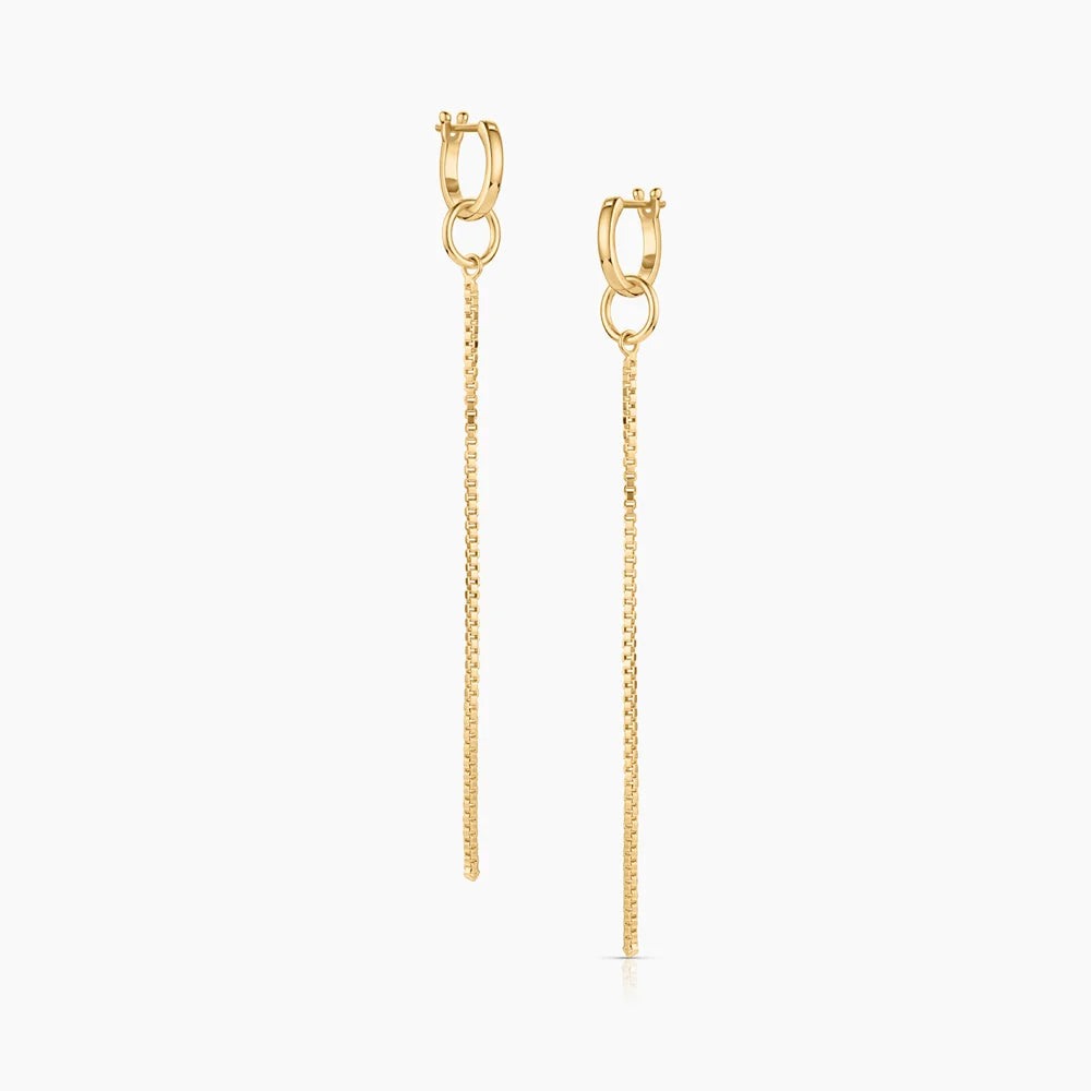 gold hoop earrings with gold jumprings attached to gold chain drops over a white background