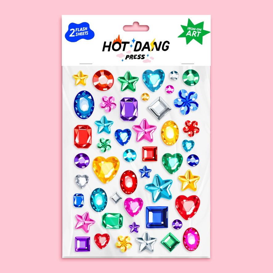 a white sheet of iron on patches of multicolored gemstones over a pink background