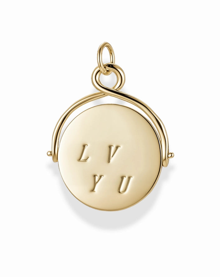 a gold disc charm with the letters L, V, Y and U on a white background