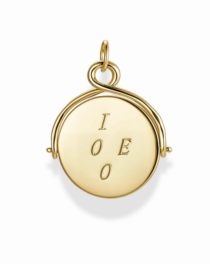 a gold disc charm with the letters I, O, E, and O on a white background