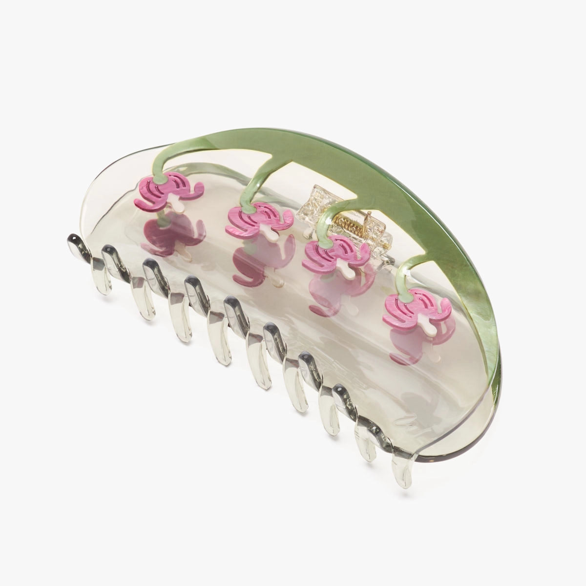 A claw clip with pink and green floral pattern on a white background