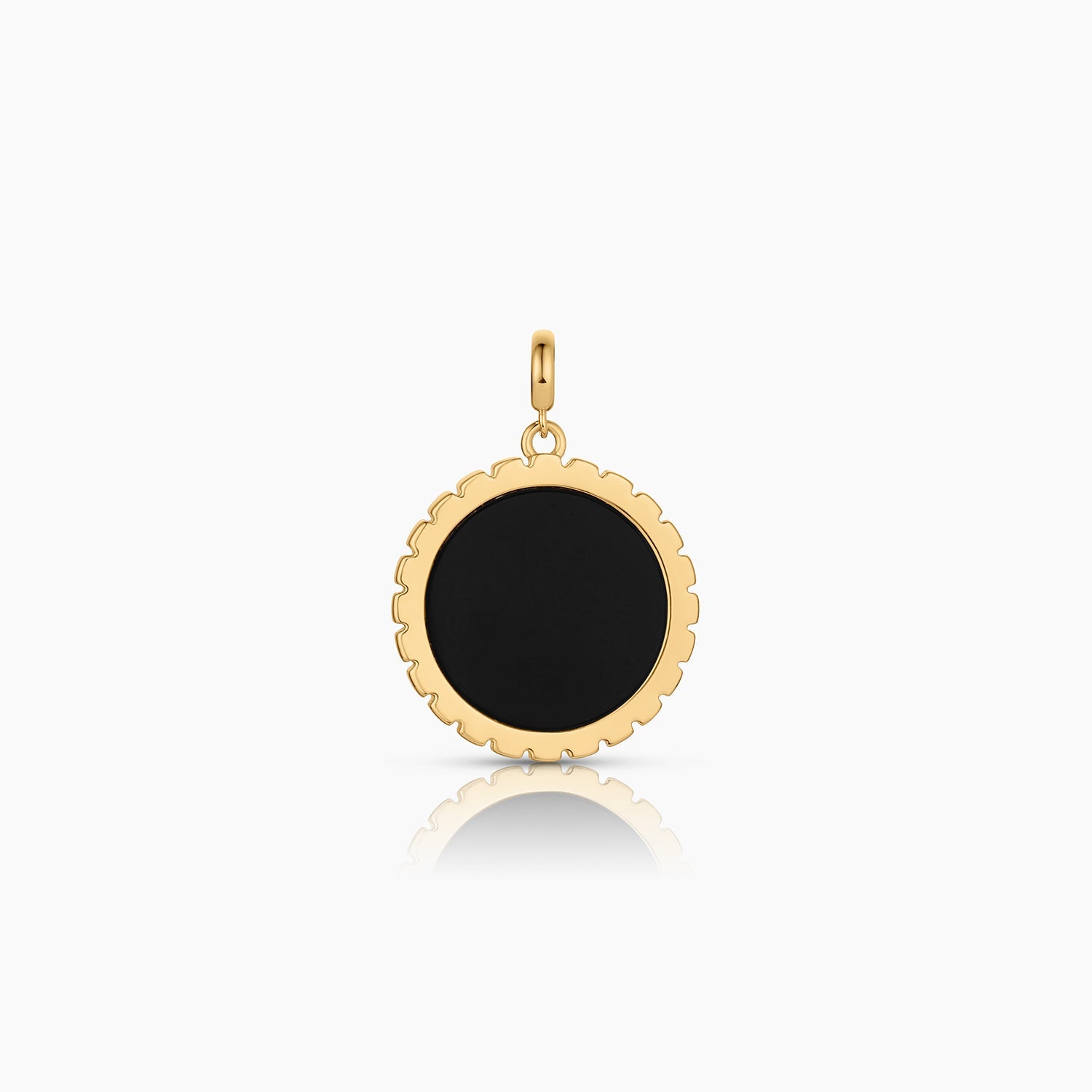 a circular gold charm with an inlay circular shaped black onyx over a white background
