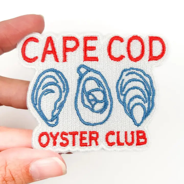 a blue and red patch with text reading cape cod oyster club and illustrations of oysters on a white background