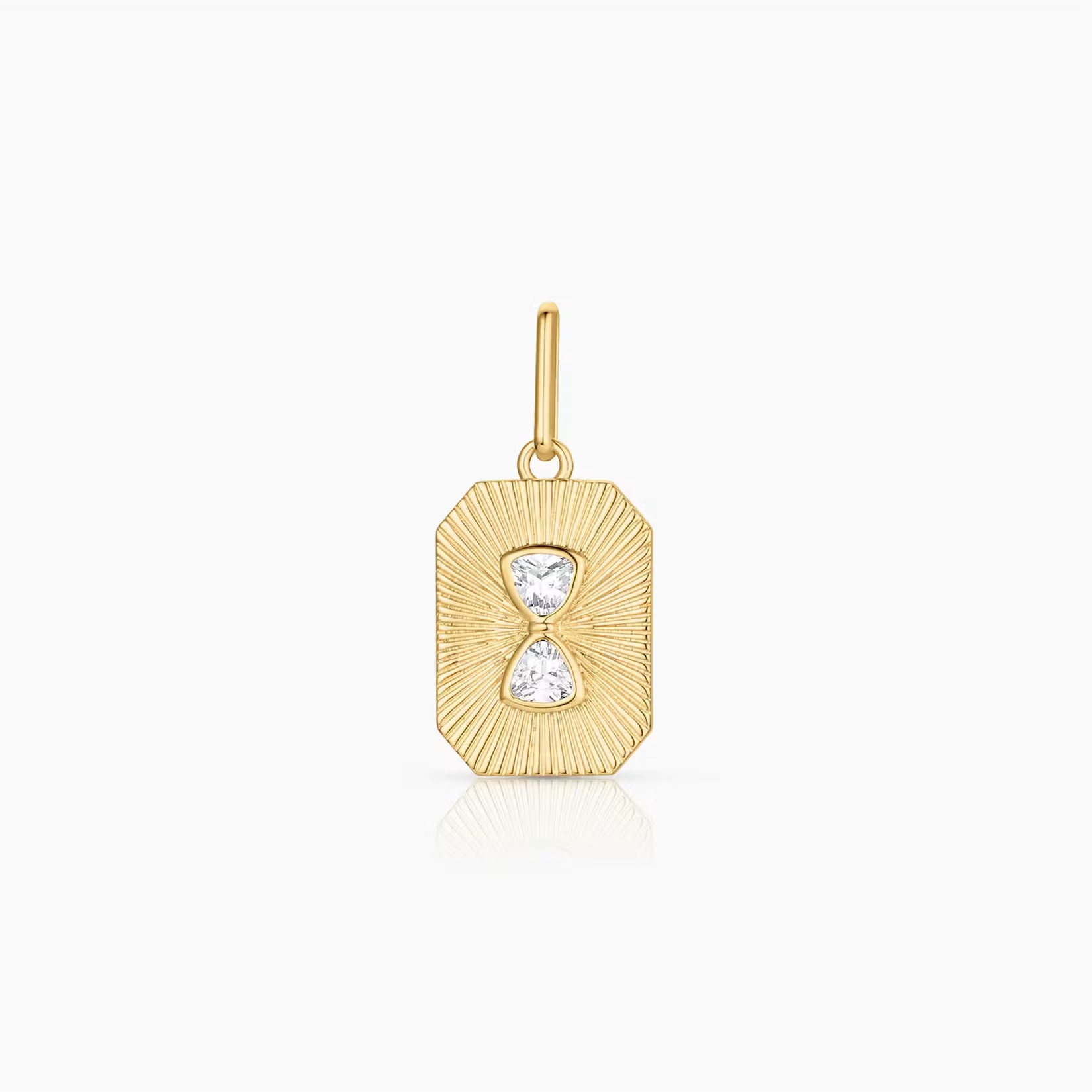 a rectangular gold charm with a subtle starburst pattern and inlay cubic zirconia in the shape of an hourglass over a white background
