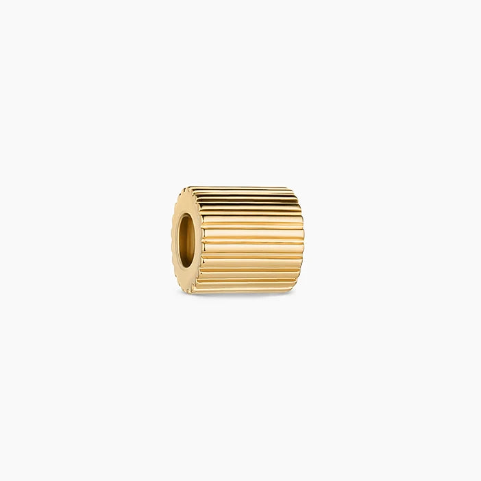 a gold bead charm with horizontal ridged edges over a white background