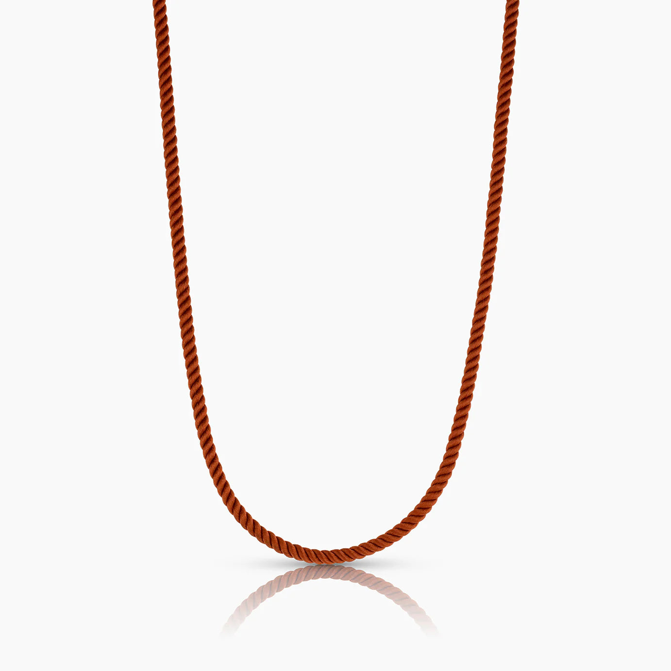 Red silk cord necklace on a white background