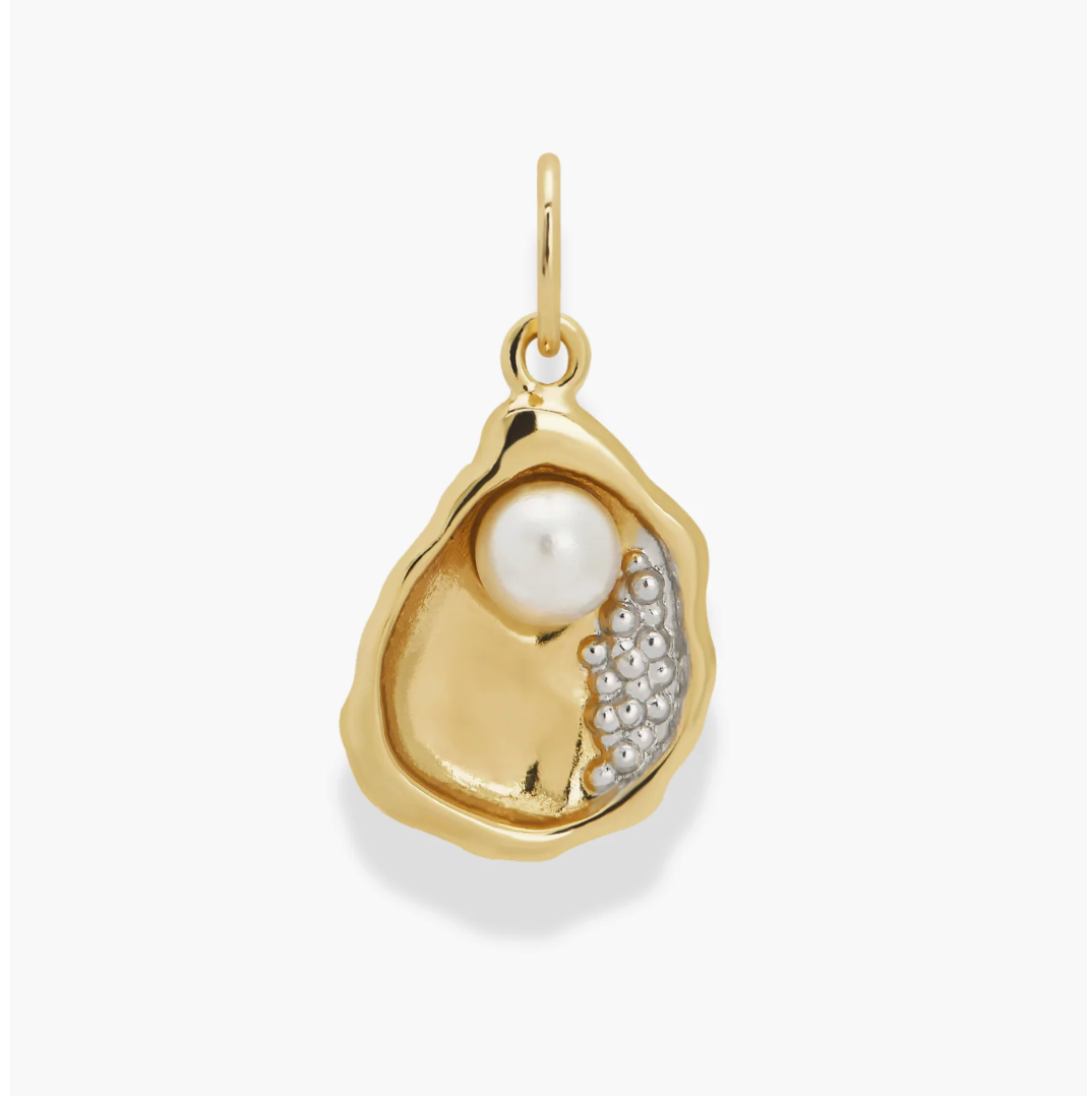 Gold oyster pendant with a pearl and small beads on a white background