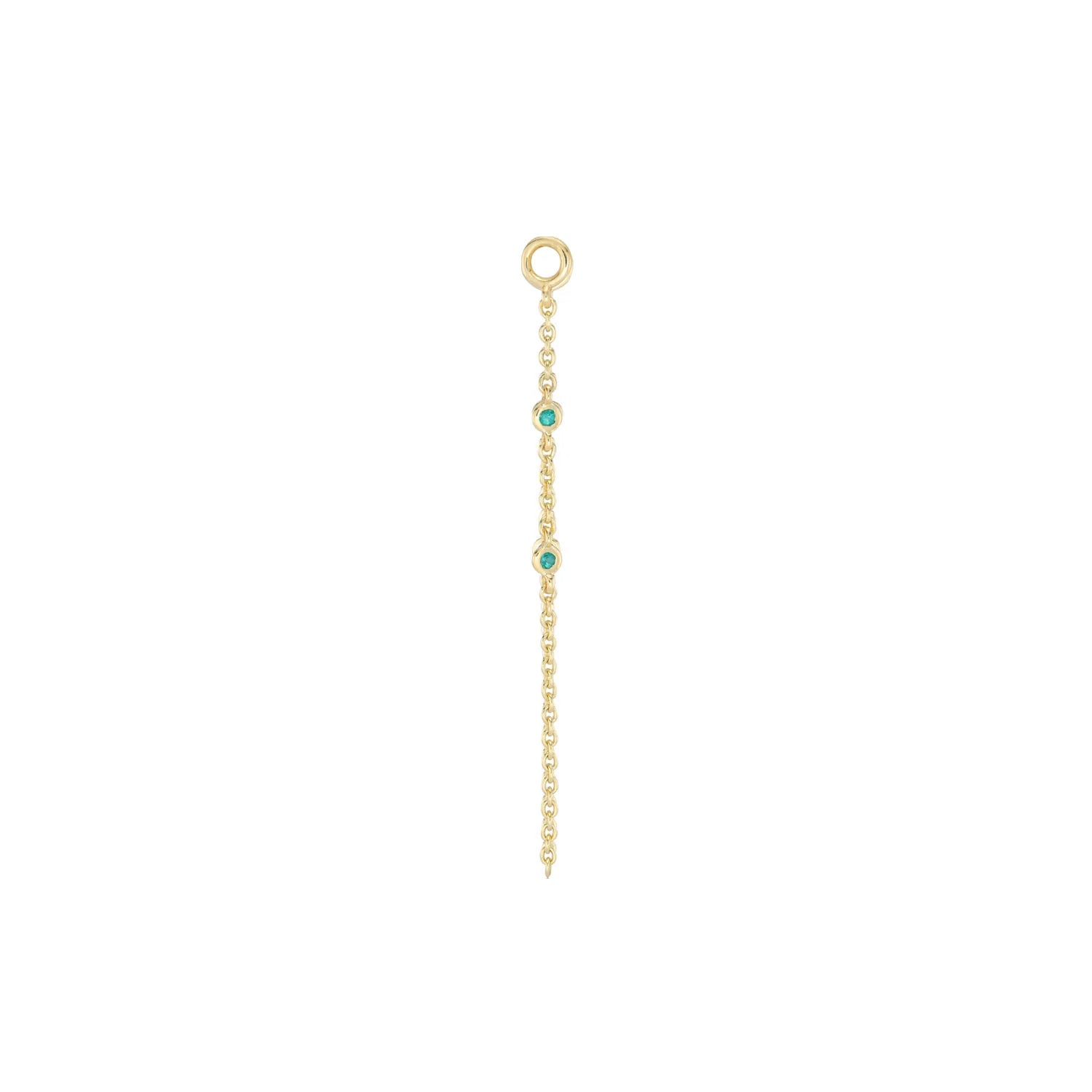 a gold chain charm with a gold jumpring and two bezel set emeralds on the chain drop over a white background