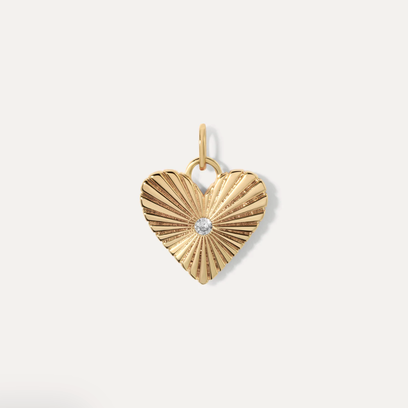 Fluted Gold heart-shaped pendant with a CZ on a white background
