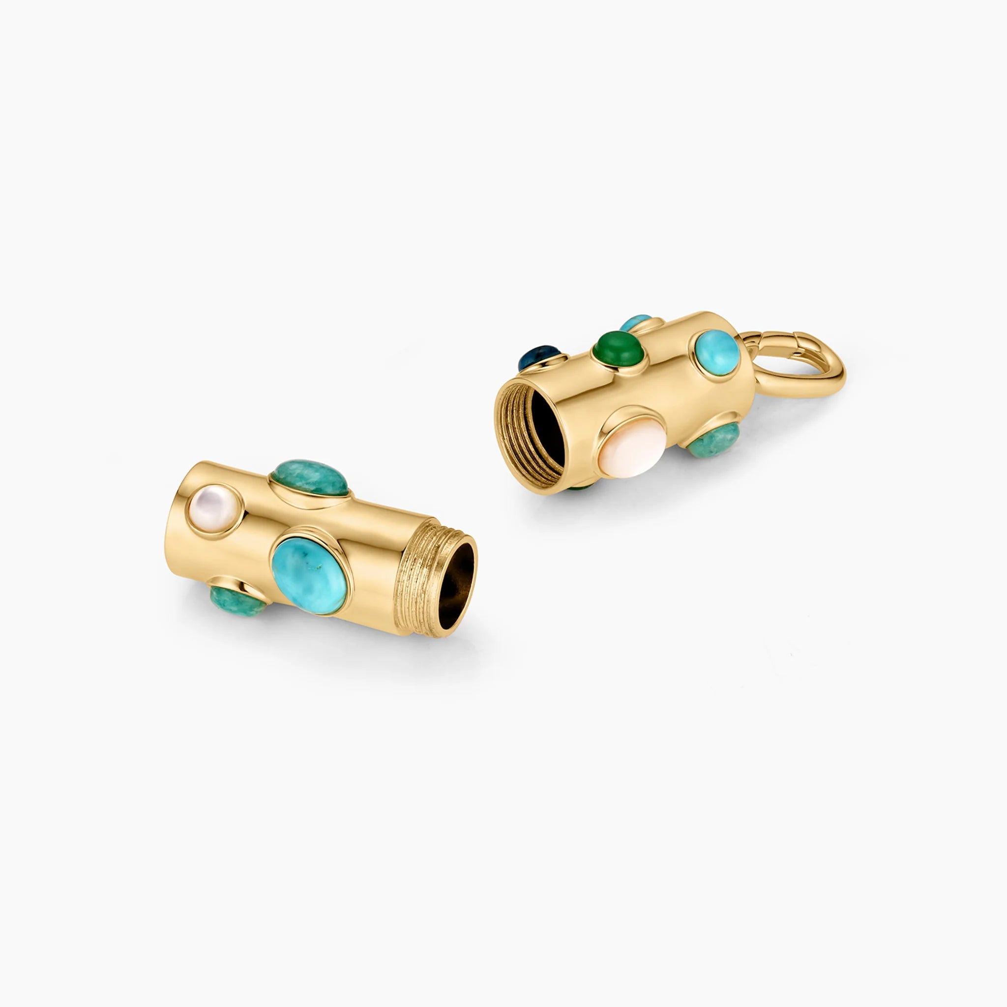 a gold charm with circular stones of various blues unscrewed into two parts over a white background