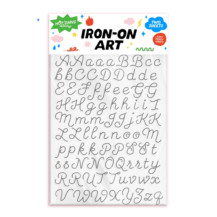 Hot Dang Iron-On Art alphabet transfer sheet featuring uppercase and cursive lowercase letters in two shades, with a decorative header card.