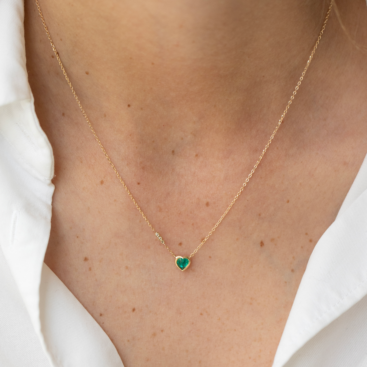 14K solid yellow gold necklace featuring a 0.5 cm emerald, known as the love stone symbolizing harmony and unconditional love — 16-inch chain, elegant and meaningful fine jewelry.