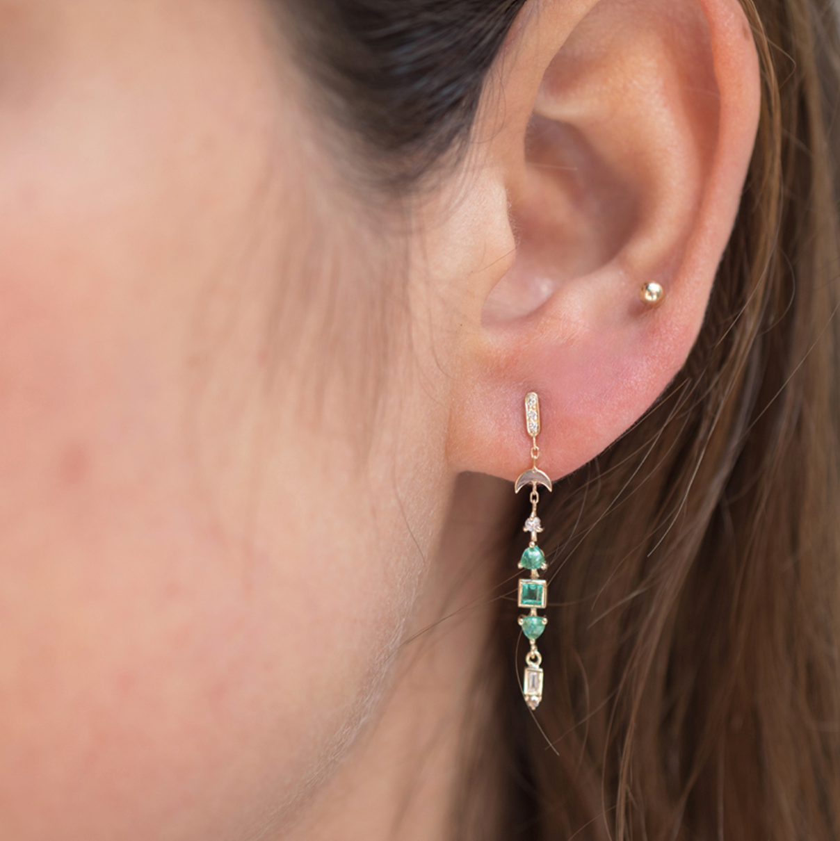 14K solid yellow gold Totem earrings with 0.13 ct diamonds and emerald accents — 3.5 cm long protective talismans symbolizing strength and spirituality, with butterfly backs, sold as a pair.