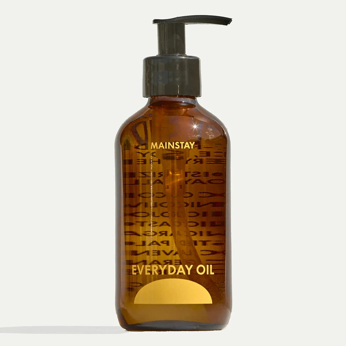 an amber bottle of everyday oil with text reading mainstay on a white backgroun