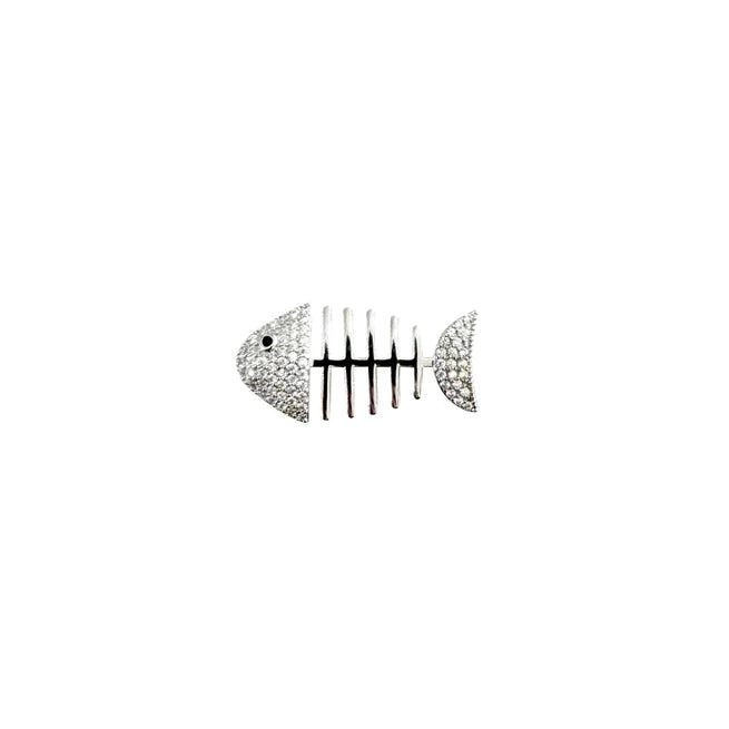 a silver brooch in the shape of a fish skeleton on a white background