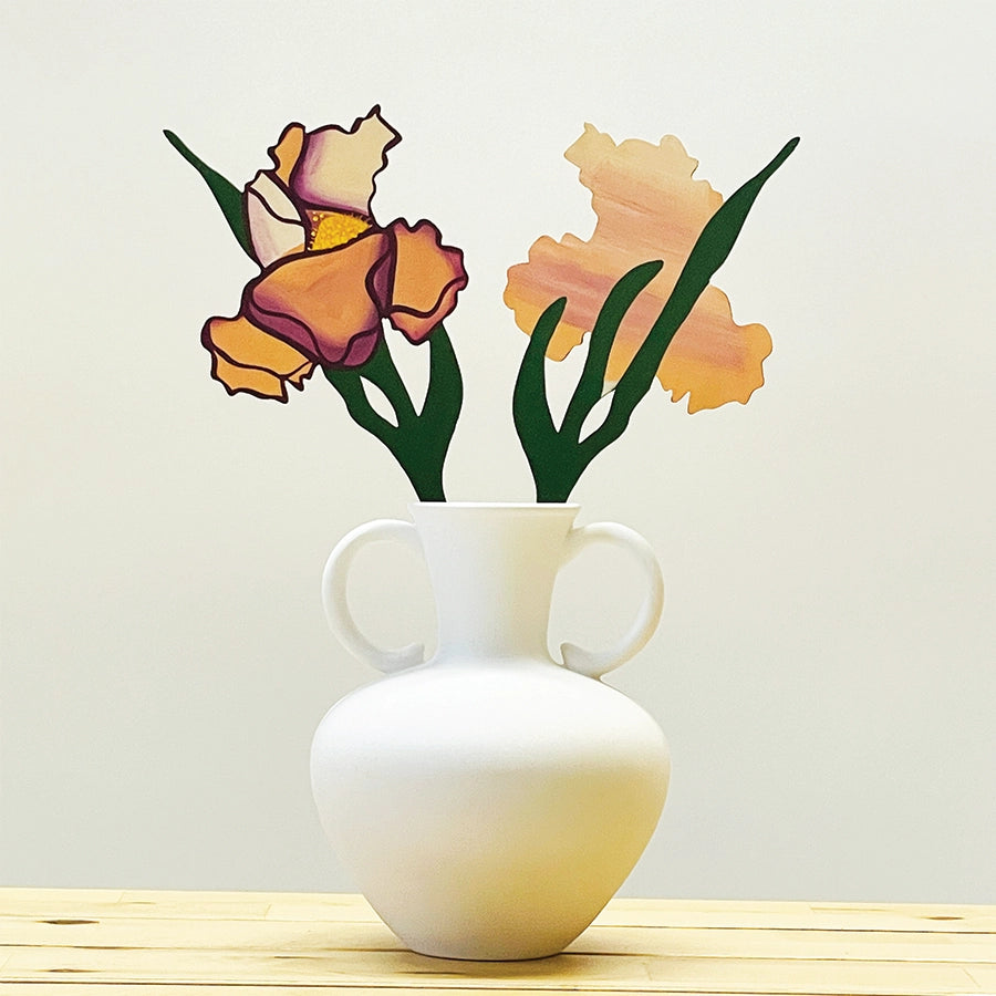 a wooden flower in a white vase on a wooden table 