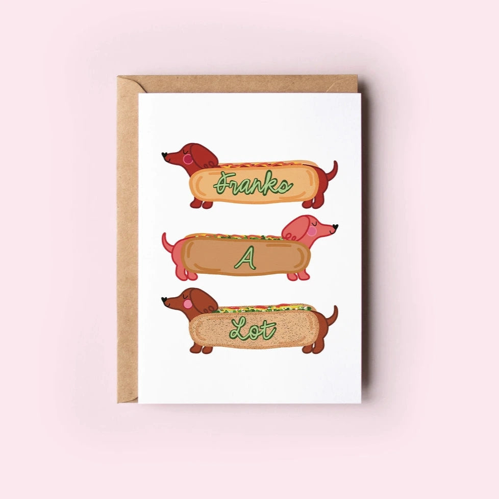 Card with cartoon hot dogs in buns on a pink background