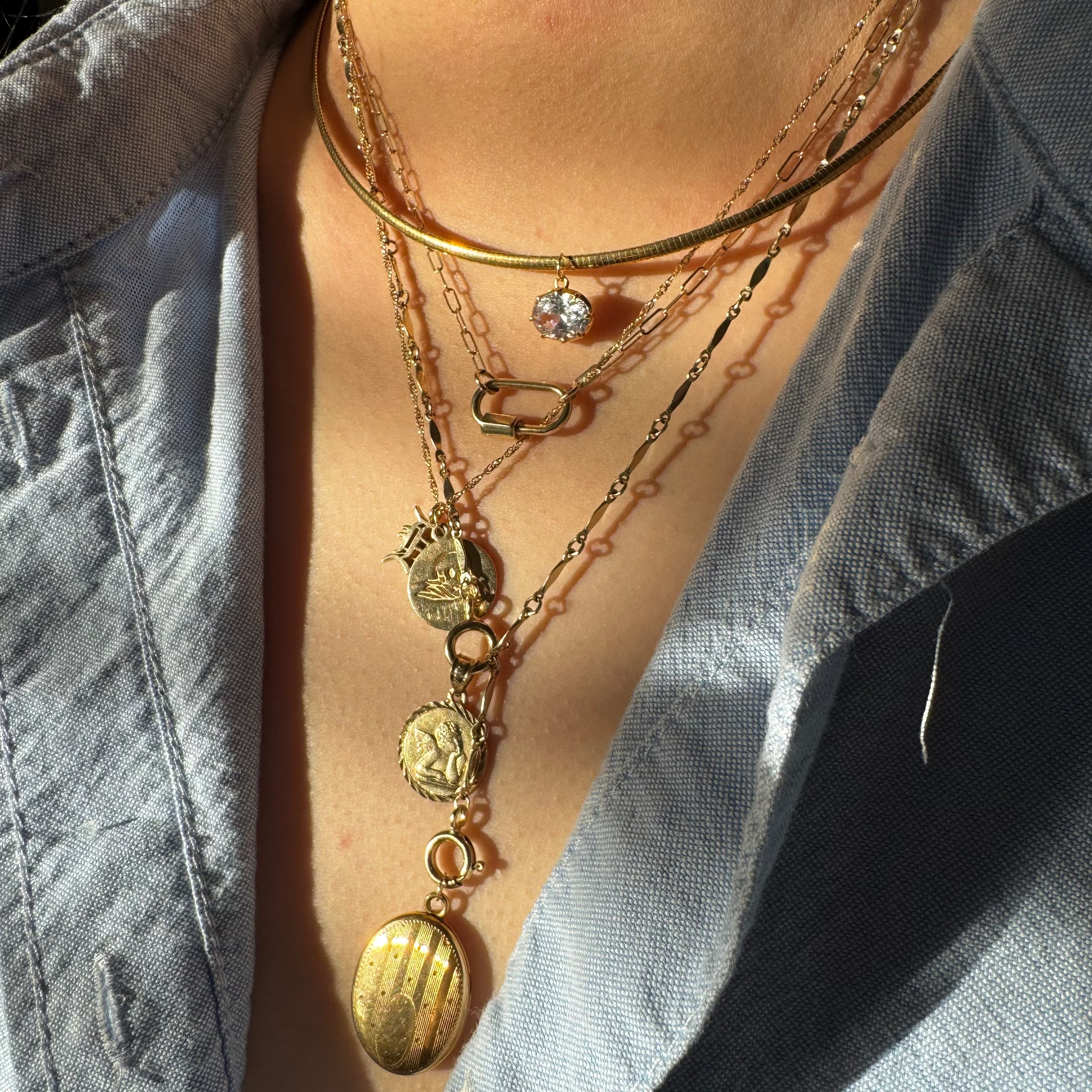 neck wearing multiple gold necklaces