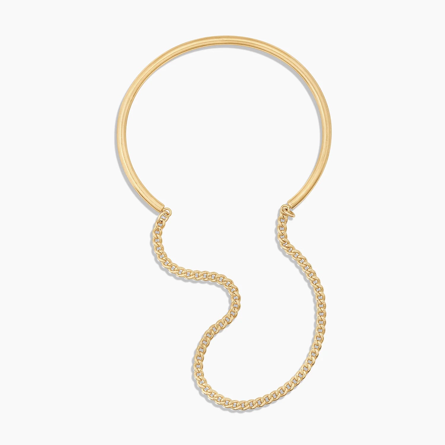 a gold bracelet made up of a cuff and chain on a white background