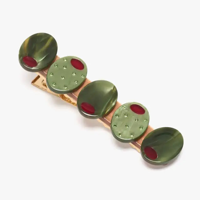 Alligator clip with green and red oval-shaped olives on a white background