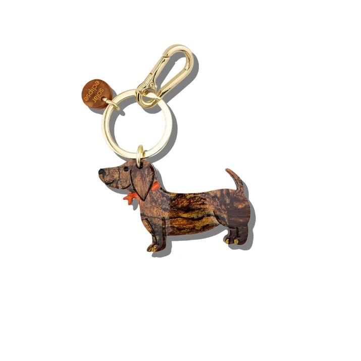 Dog-shaped keychain with a gold ring on a white background