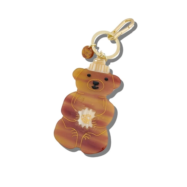 Bear-shaped keychain with a gold chain on a white background