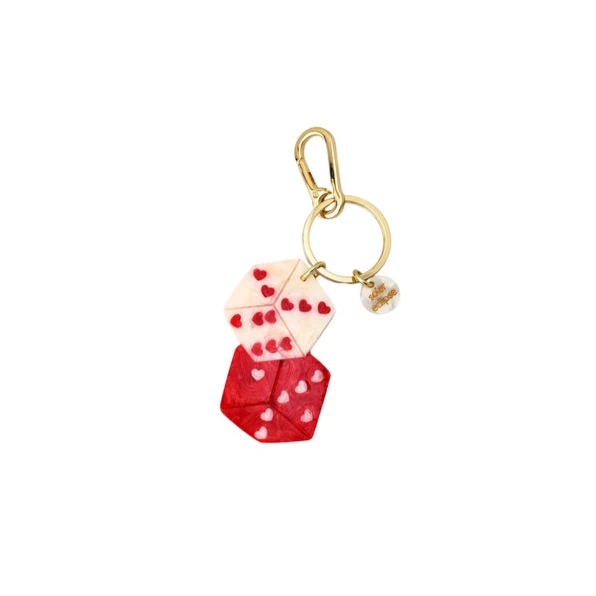 Keychain with red and white dice design on a white background