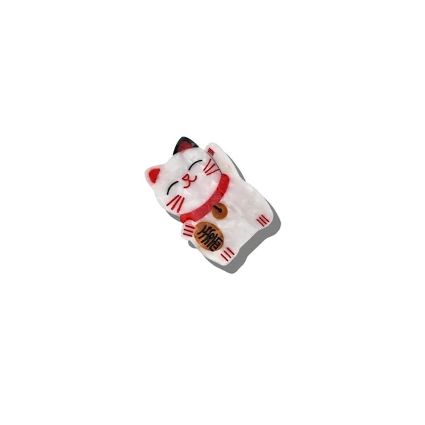 White cat-shaped claw clip with red accents on a white background