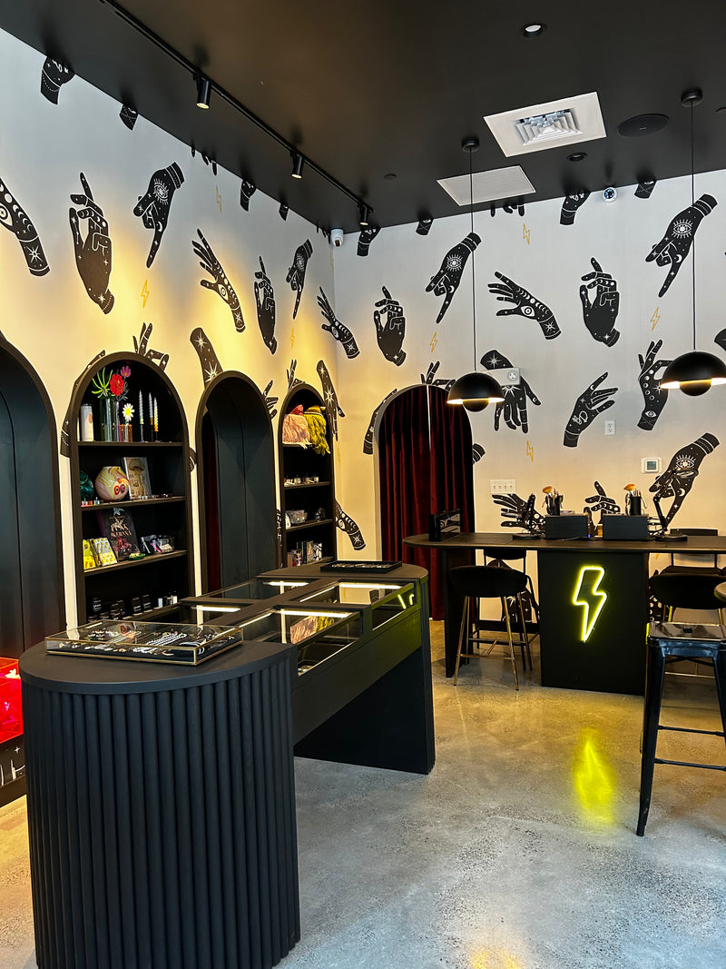 Brave Daughters Seaport Boston location — boutique studio with permanent jewelry welding bar, curated fine jewelry, and bold graphic interior design.