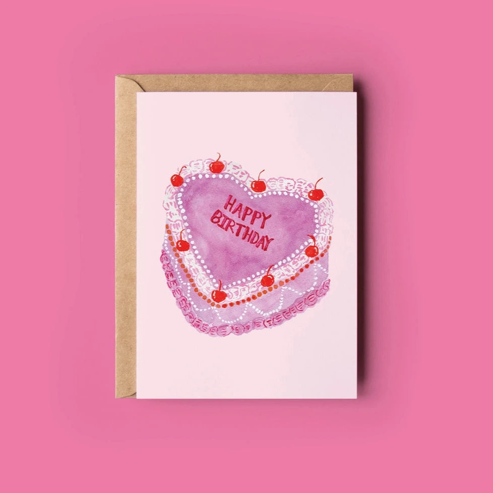 Greeting card with a heart-shaped birthday cake design on a pink background