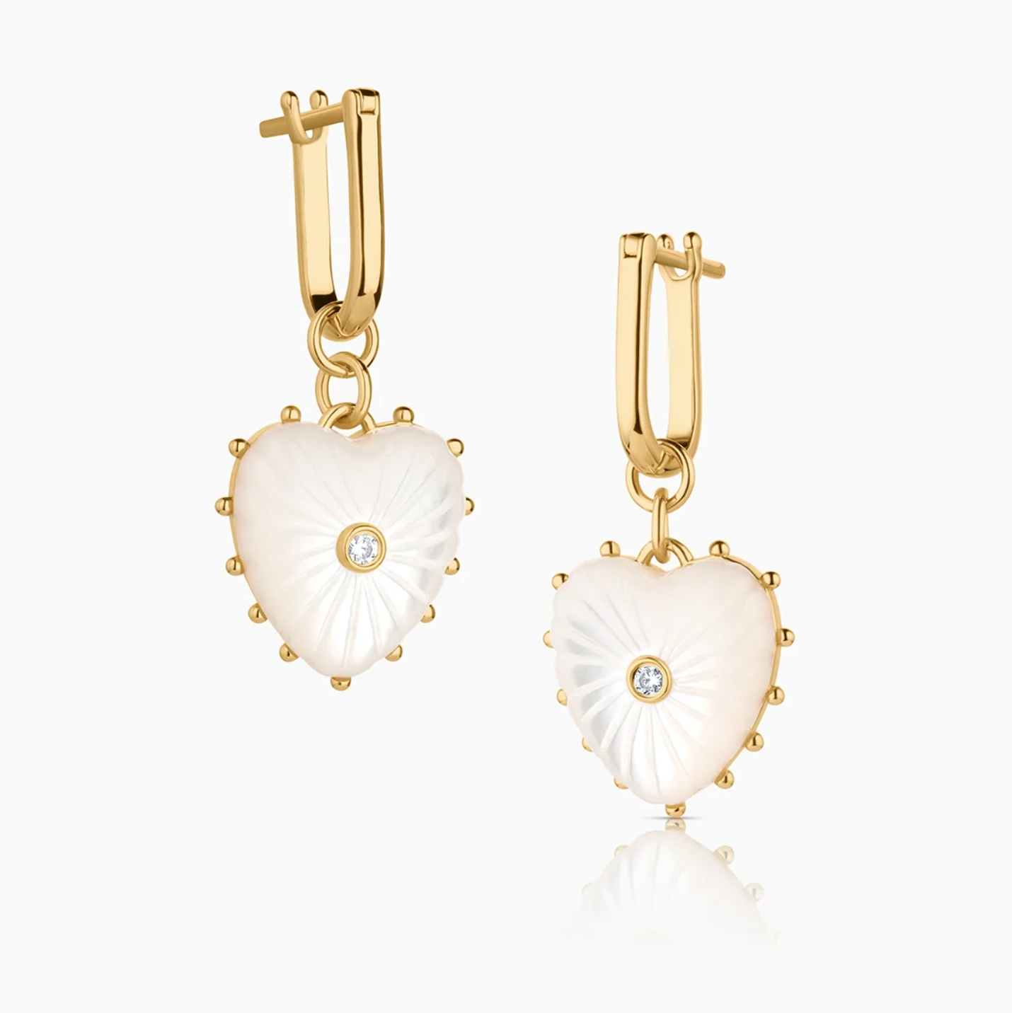 14k gold plated hoop earrings with removable hand-carved mother of pearl heart charms and cubic zirconia center stones.