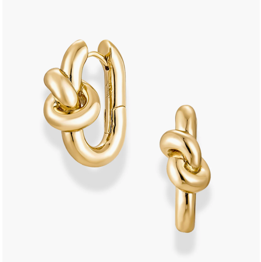 Gold knot earrings on a white background