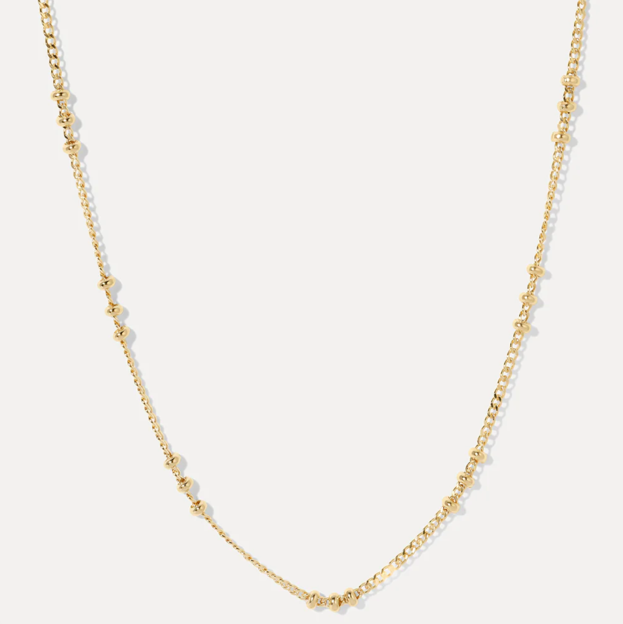 Gold fill beaded necklace on a light gray background